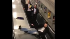 Drunk Guy Attempts to Walk Down the Up Escalator and Ends Up Knocking Himself Out
